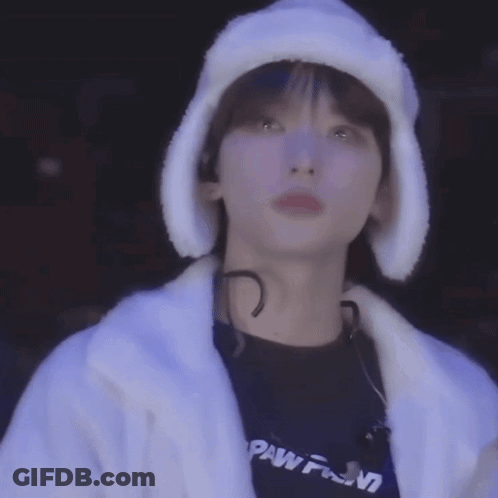 A Close Up Of A Person Wearing A Fur Hat And A White Coat . GIF