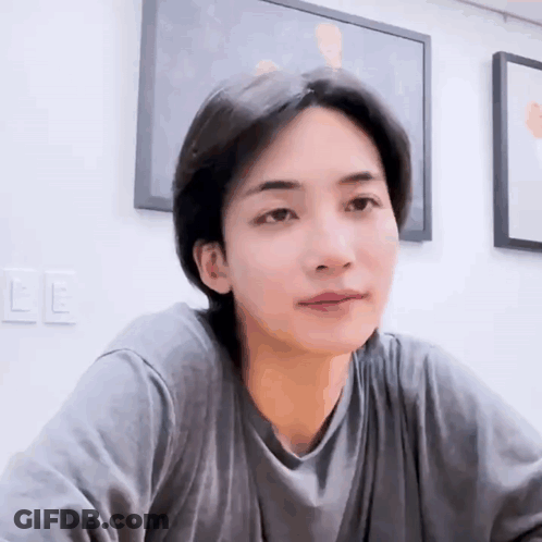 A Close Up Of A Person Wearing A Gray Shirt . GIF