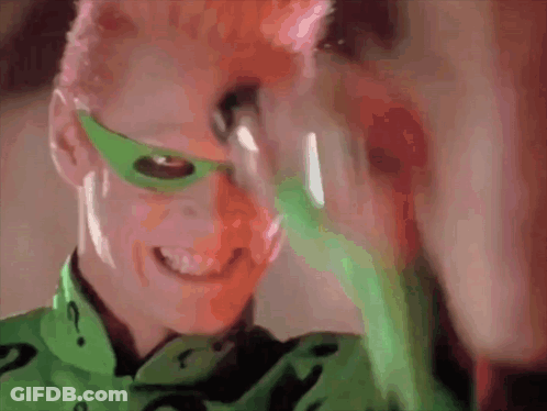 A Close Up Of A Person Wearing A Green Mask And A Green Shirt With A Question Mark On It GIF