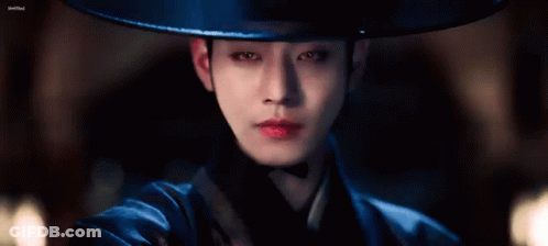 A Close Up Of A Person Wearing A Hat And A Blue Costume . GIF