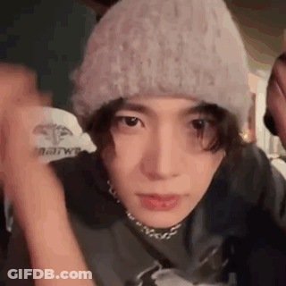 A Close Up Of A Person Wearing A Hat And A Choker . GIF