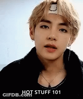 A Close Up Of A Person Wearing A Headband And A Necklace With The Words `` Hot Stuff 101 '' . GIF