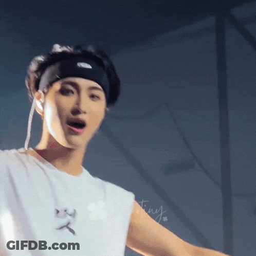 A Close Up Of A Person Wearing A Headband And A White Shirt GIF