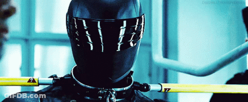 A Close Up Of A Person Wearing A Helmet And A Collar With A Yellow Warning Sign GIF