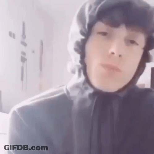 A Close Up Of A Person Wearing A Hooded Jacket And Hat . GIF