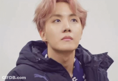 A Close Up Of A Person Wearing A Hoodie And A Scarf . GIF