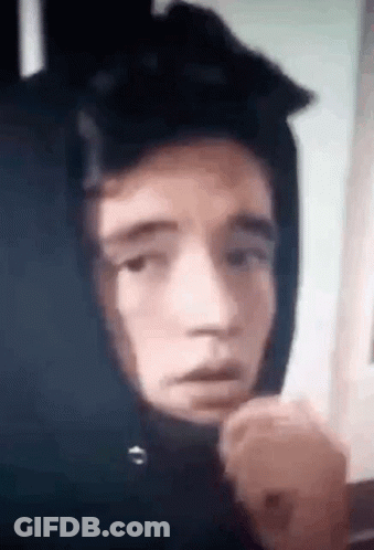 A Close Up Of A Person Wearing A Hoodie With A Hood On Their Head . GIF