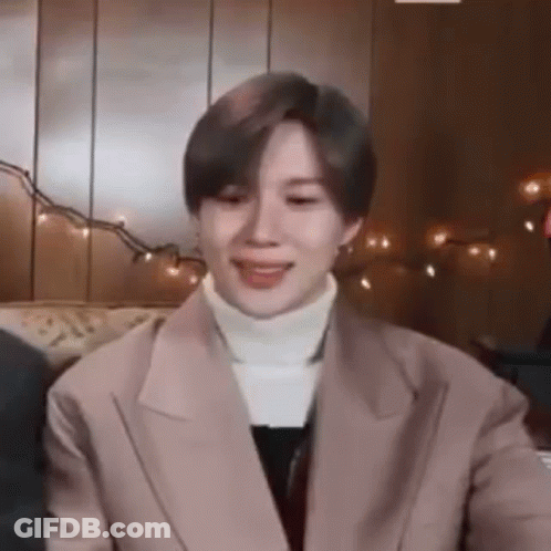 A Close Up Of A Person Wearing A Jacket And A White Turtleneck . GIF