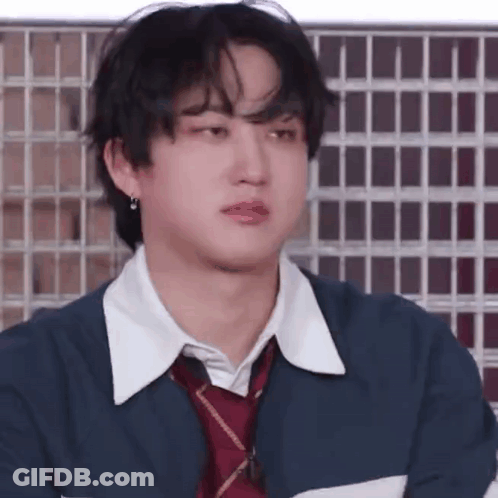 A Close Up Of A Person Wearing A Jacket And Tie . GIF