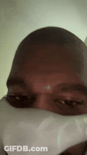 A Close Up Of A Person Wearing A Mask GIF