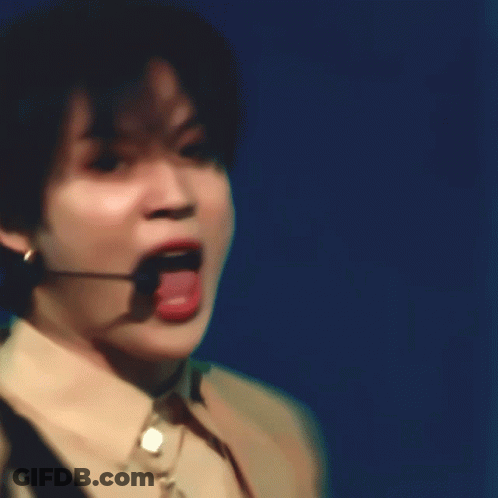 A Close Up Of A Person Wearing A Microphone And A Necklace GIF