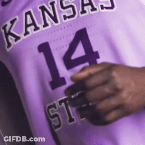 A Close Up Of A Person Wearing A Purple Basketball Jersey With The Number 14 On It . GIF