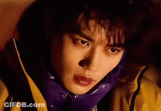 A Close Up Of A Person Wearing A Purple Jacket And A Yellow Jacket . GIF