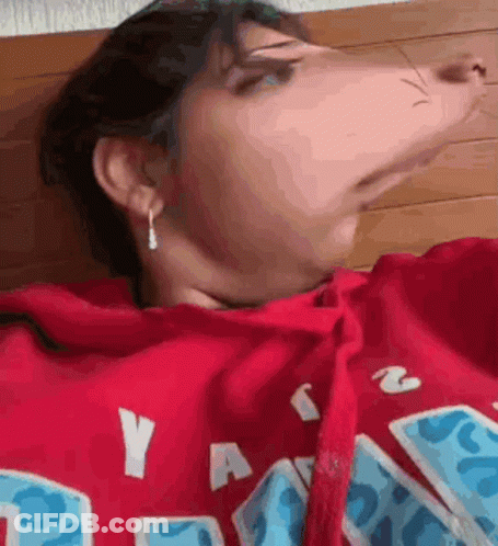 A Close Up Of A Person Wearing A Red Hoodie . GIF