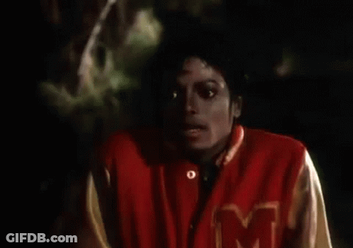 A Close Up Of A Person Wearing A Red Jacket With The Letter M On It GIF