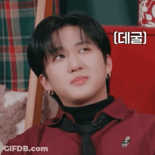 A Close Up Of A Person Wearing A Red Shirt And Tie Making A Funny Face . GIF