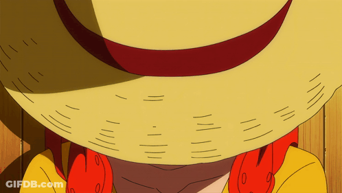A Close Up Of A Person Wearing A Straw Hat With A Red Ribbon GIF