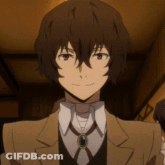 A Close Up Of A Person Wearing A Suit And Tie With A Necklace . GIF