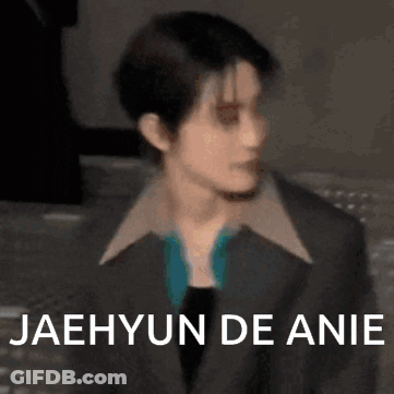 A Close Up Of A Person Wearing A Suit With The Words `` Jaehyun De Anie '' On It . GIF