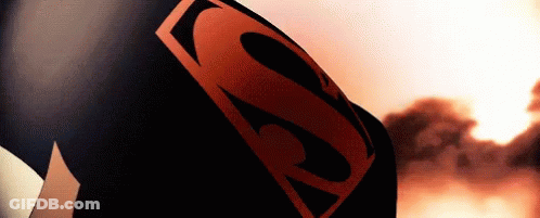 A Close Up Of A Person Wearing A Superman Costume With A Red S On It . GIF