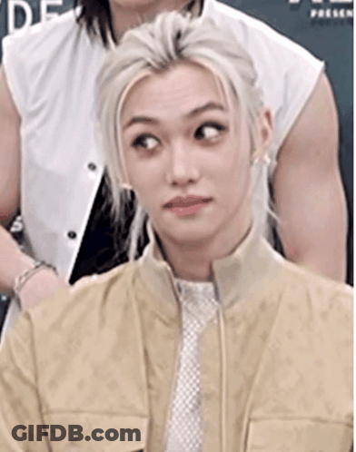 A Close Up Of A Person Wearing A Tan Jacket And Tie . GIF