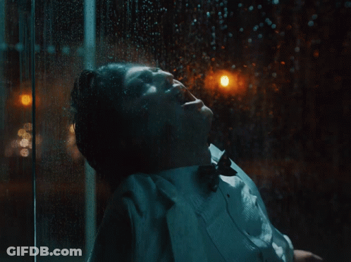 A Close Up Of A Person Wearing A White Coat With A Black Background GIF