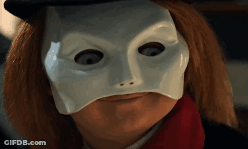 A Close Up Of A Person Wearing A White Mask And A Red Scarf GIF