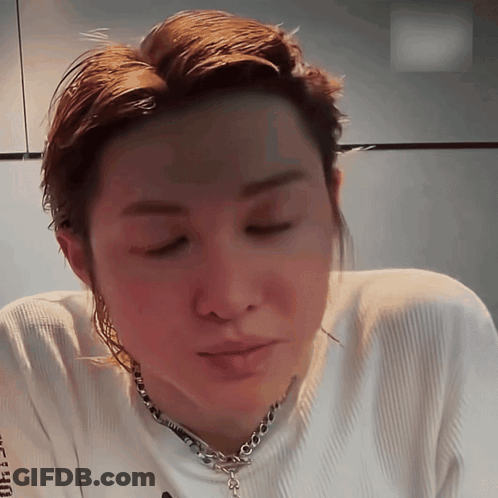 A Close Up Of A Person Wearing A White Shirt And A Chain GIF
