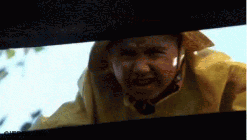 A Close Up Of A Person Wearing A Yellow Raincoat And A Hat GIF