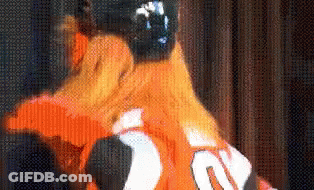 A Close Up Of A Person Wearing An Orange Jersey With The Number 20 On The Back GIF