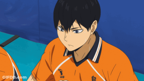 A Close Up Of A Person Wearing An Orange Shirt With Ics On It GIF