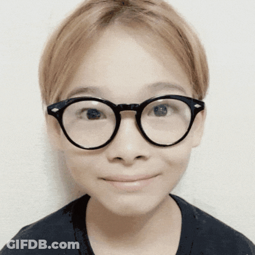 A Close Up Of A Person Wearing Glasses Against A White Background GIF