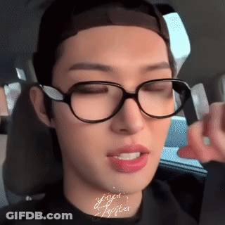 A Close Up Of A Person Wearing Glasses And A Black Shirt GIF