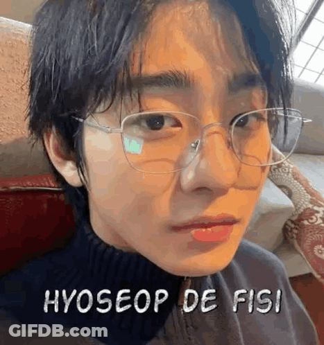 A Close Up Of A Person Wearing Glasses And A Black Sweater . GIF