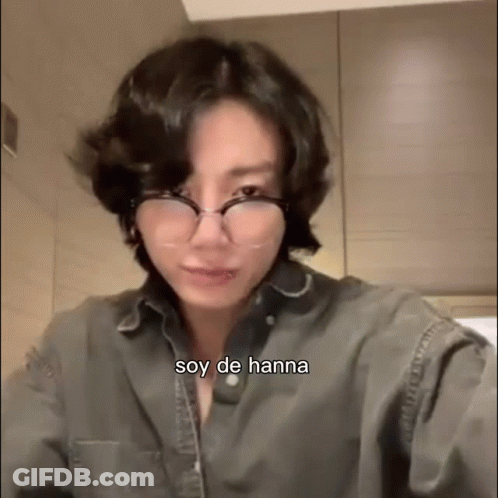 A Close Up Of A Person Wearing Glasses And A Gray Shirt . GIF