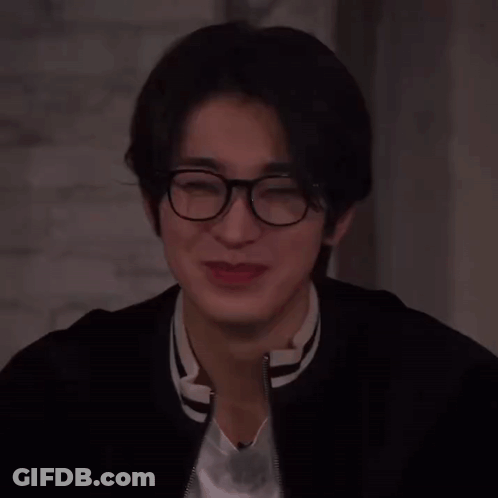 A Close Up Of A Person Wearing Glasses And A Jacket GIF