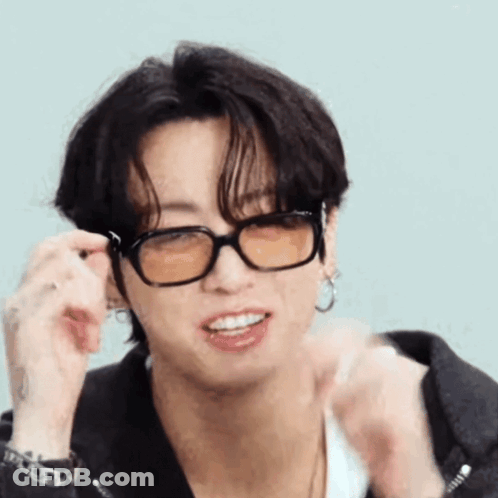 A Close Up Of A Person Wearing Glasses And A Jacket . GIF