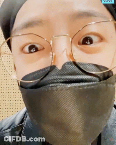 A Close Up Of A Person Wearing Glasses And A Mask That Says Vlive On The Bottom GIF