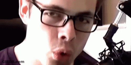 Close Up Of Person Wearing Glasses And Purple Shirt GIF