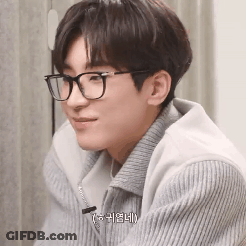 A Close Up Of A Person Wearing Glasses And A Sweater . GIF