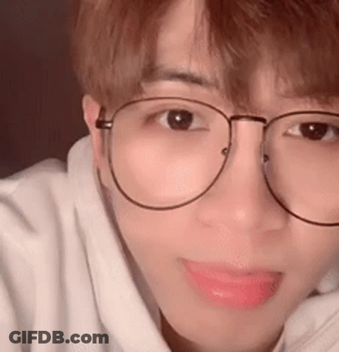 A Close Up Of A Person Wearing Glasses And A White Sweatshirt . GIF