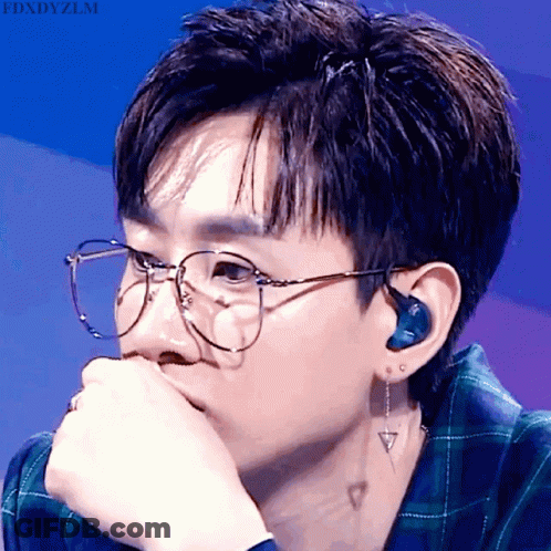 A Close Up Of A Person Wearing Glasses And Ear Buds With The Words Fdxdyzlm Above GIF