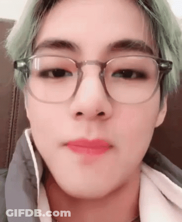 A Close Up Of A Person Wearing Glasses And Lipstick . GIF