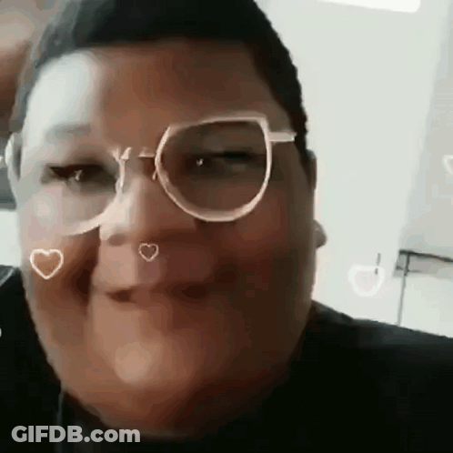 A Close Up Of A Person Wearing Glasses And Making A Face . GIF