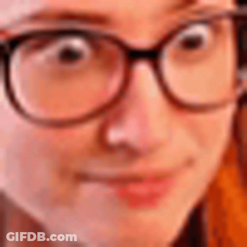 A Close Up Of A Person Wearing Glasses And Making A Funny Face . GIF