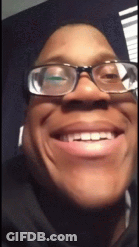 A Close Up Of A Person Wearing Glasses And Making A Funny Face GIF