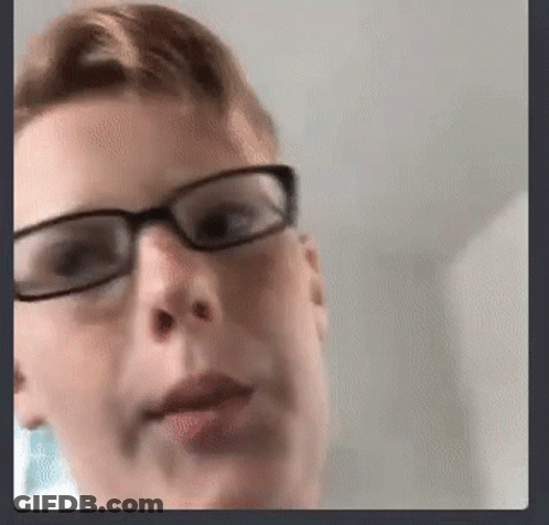 A Close Up Of A Person Wearing Glasses And Making A Funny Face . GIF