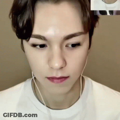 A Close Up Of A Person Wearing Headphones And A White Shirt GIF