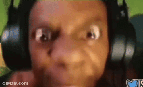 A Close Up Of A Person Wearing Headphones And Making A Face GIF