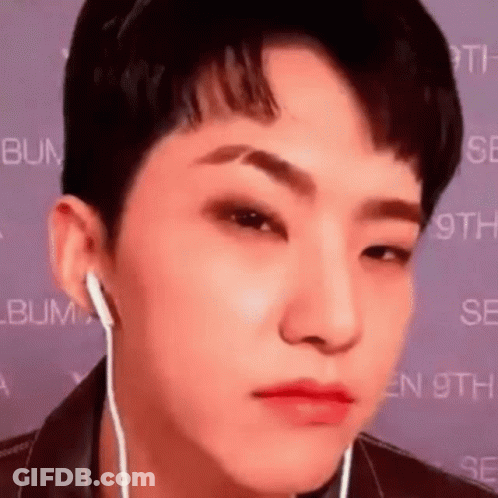 A Close Up Of A Person Wearing Headphones And Making A Face . GIF